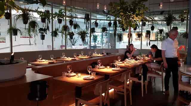 Modern cocktail bar in NENI Amsterdam with inviting ambiance for upscale dinners.