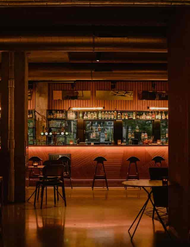 Modern wine bar with ambient lighting, perfect for networking and casual meetings.