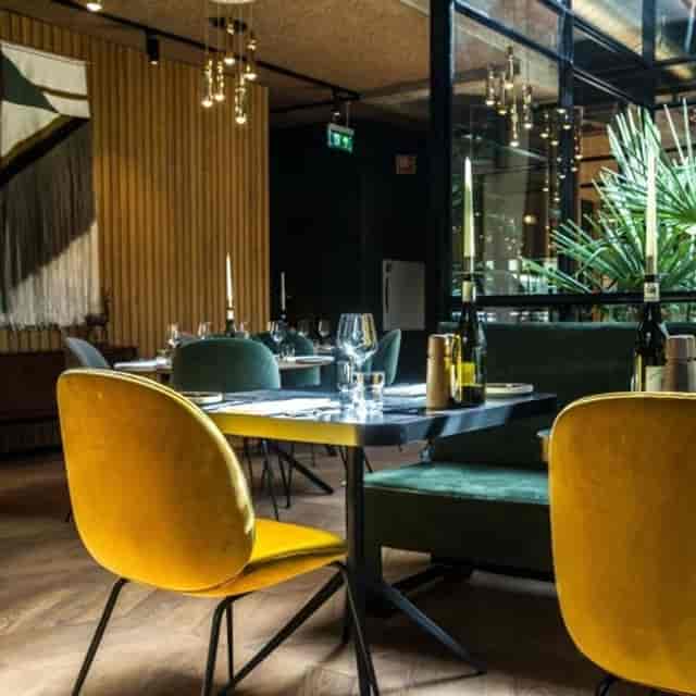 Stylish wine bar with vibrant chairs, perfect for intimate gatherings and networking events.