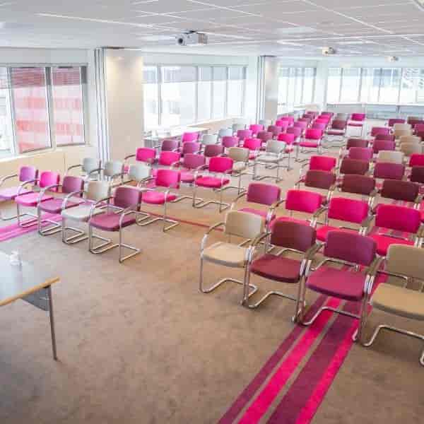 Colorful chairs in La Place meeting room for vibrant workshops and presentations.
