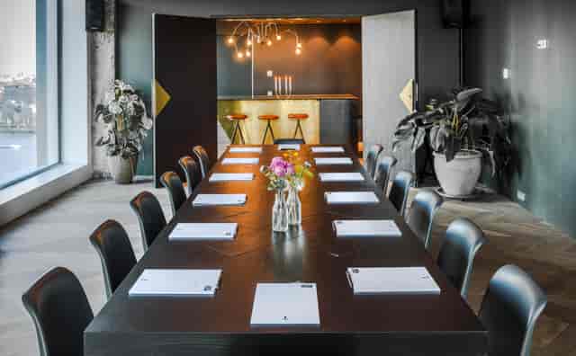 Modern A'DAM Toren meeting room with stylish bar, perfect for strategic planning sessions.