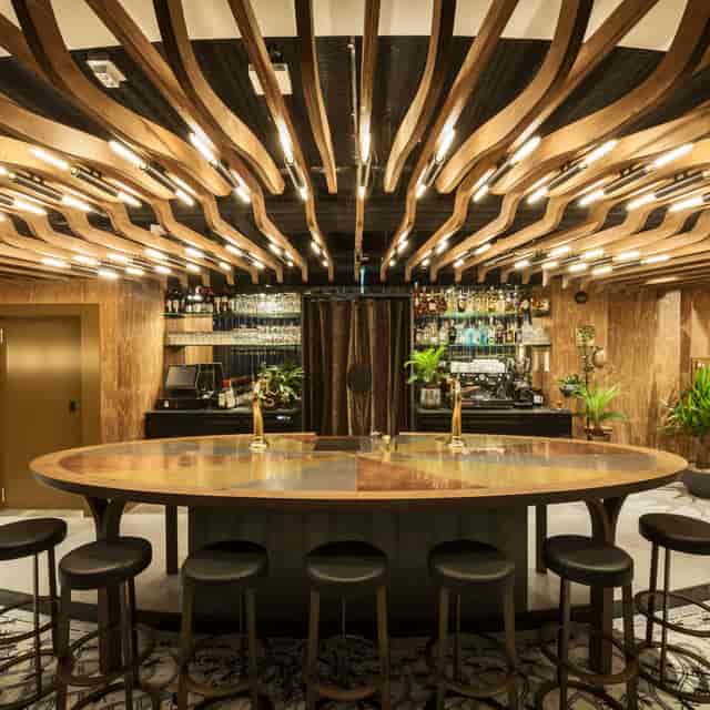 Stylish bar with wood-beamed ceiling, ideal for networking events in A'DAM Toren.