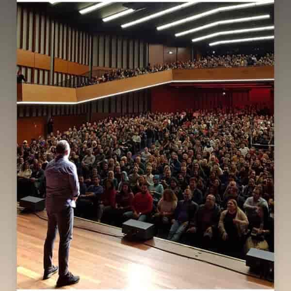 Packed auditorium at RAI Amsterdam Theatre showcasing engaged audience during a successful event.