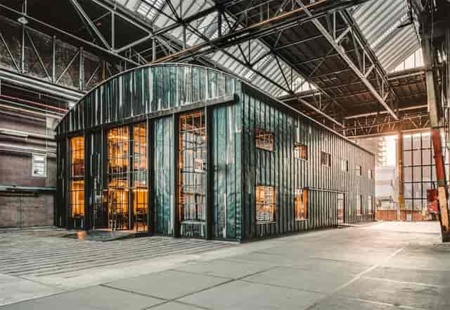 NDSM Theater: modern industrial event space with large glass windows, ideal for gatherings.