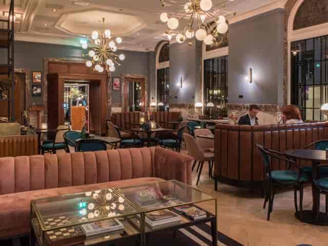 Chic lounge at Hotel Indigo The Hague, ideal for networking events and gatherings.