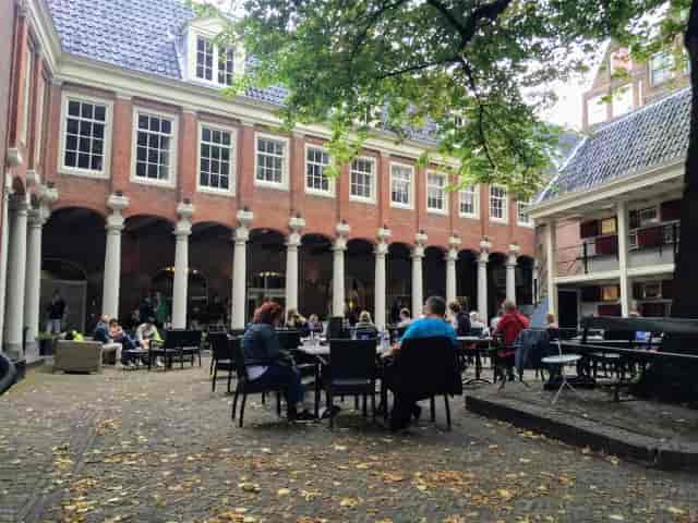 Charming outdoor venue at H'ART Museum for meetings and events with lush greenery.