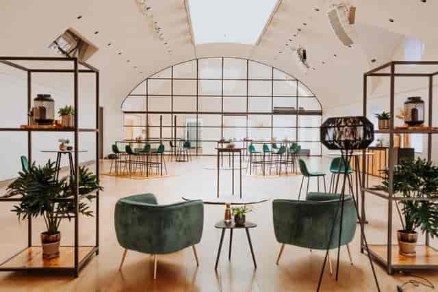 Modern event space in H'ART Museum with natural light and stylish seating arrangements.