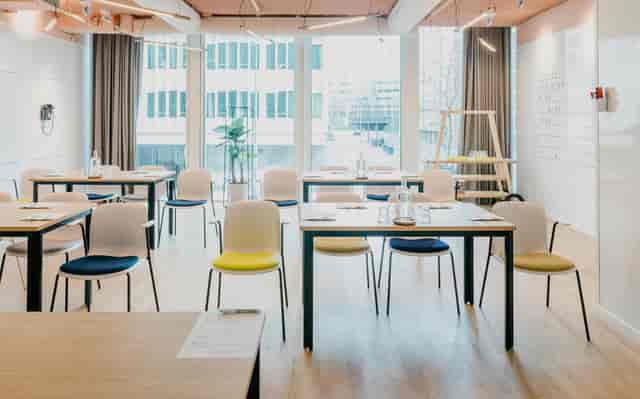 Bright coworking space in Hotel Casa with colorful chairs for workshops and corporate events.