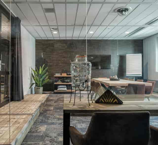 Modern meeting room with plants and wooden accents ideal for collaboration events.