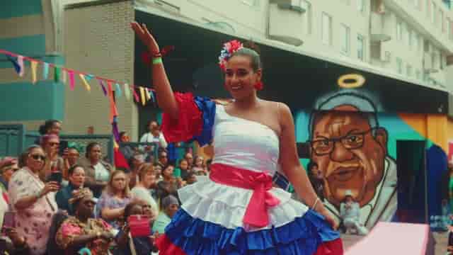 Colorful performer at outdoor cultural event in Amsterdamse Poort, showcasing local pride.