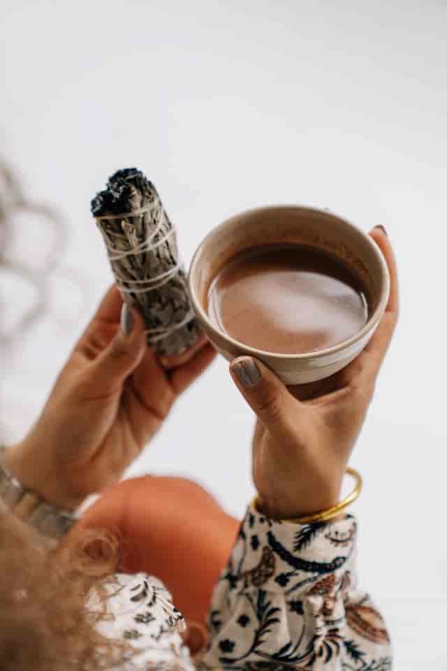 Cacao ceremony with warm beverage and sage, ideal for mindfulness and creative events.