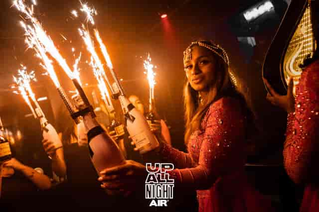 Sky Room at Air Amsterdam: vibrant nightlife event with champagne and sparklers.