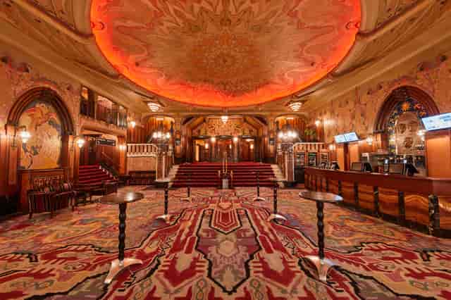 Ornate Tuschinski theater venue with grand ceiling, ideal for upscale events and galas.