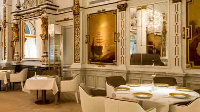 Elegant dining space in The White Room for corporate dinners and intimate events.
