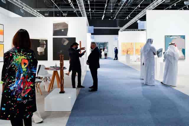 Art exhibition in Abu Dhabi showcasing vibrant networking and creativity.