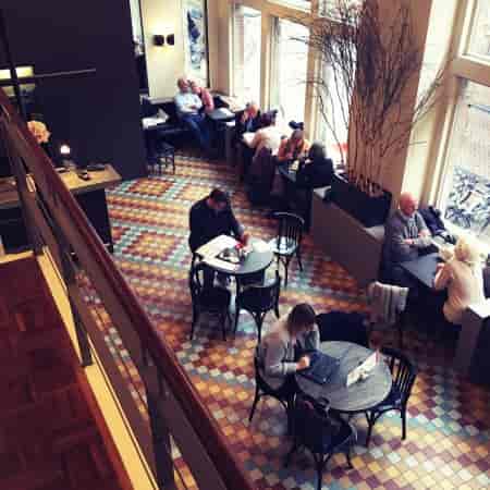 Vibrant Café de Jaren with tiled floor, perfect for networking and casual meetings.