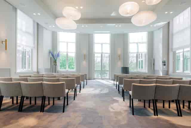 Maurits Room conference setup with natural light for events and networking.