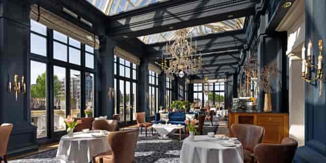 Elegant dining space with glass ceiling in Amstel Hotel, ideal for upscale events.
