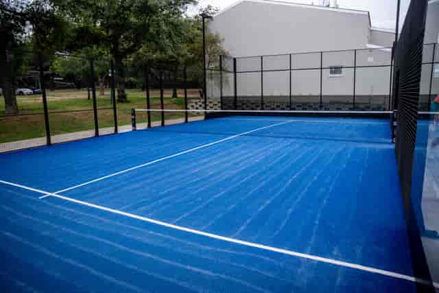 Blue tennis court at Bryanston Country Club for corporate events and networking.