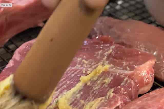 Close-up of marinated meat for grilling at Smokin' Grill Steakhouse event catering.