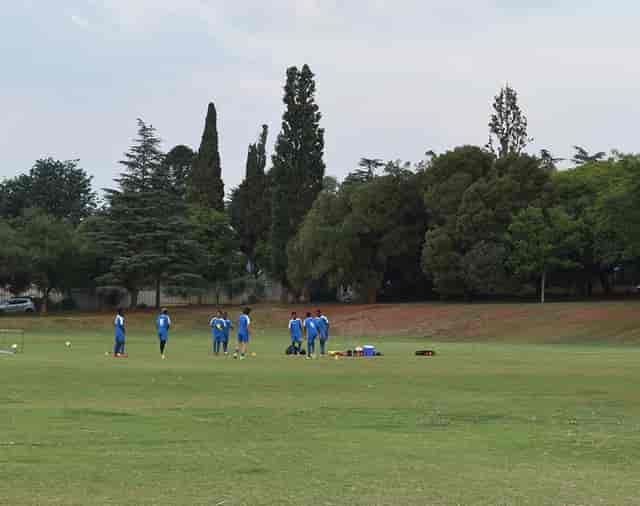 Sportsman’s Bar in Marks Park: team practicing on green field, ideal for outdoor sports events.