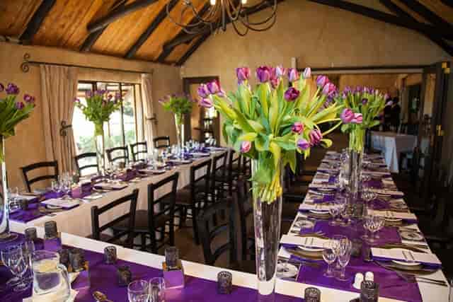 Elegant dining room setup with tulip centerpieces for formal events and celebrations.