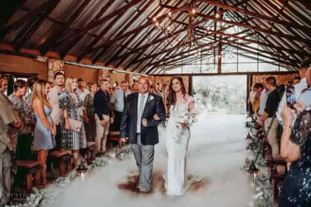 Indoor wedding ceremony at Veranda, featuring bride in a romantic rustic setting.