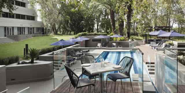 Elegant poolside dining area at Bistro, The Maslow Sandton – perfect for meetings and events.