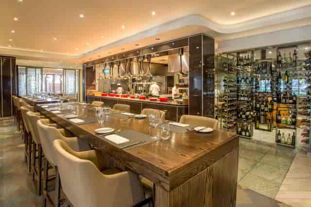 Function room at The Maslow Sandton with open kitchen, ideal for networking events.