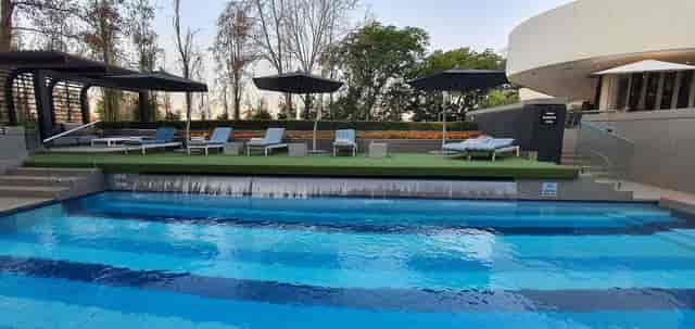 Stylish outdoor meeting room with serene pool, perfect for upscale events and conferences.