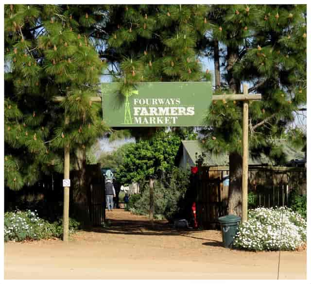 Fourways Farmers Market entrance with rustic sign, ideal for outdoor community events.