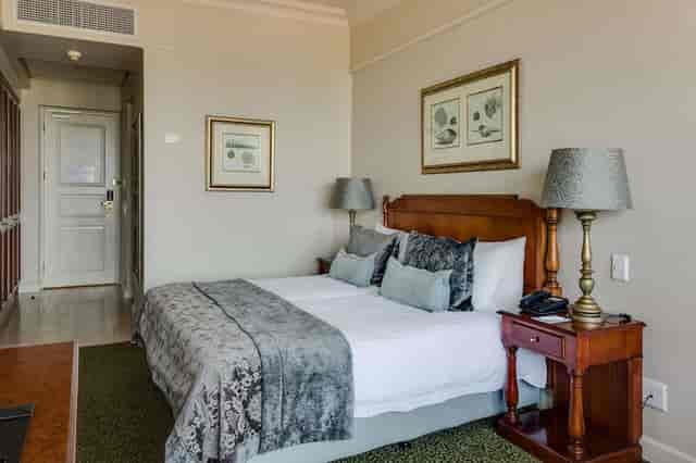 Cozy conference room with twin beds at The Edward, perfect for meetings and networking.