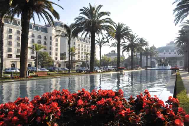 Elegant Red Roman Shed venue with palm trees, ideal for upscale events and gatherings.