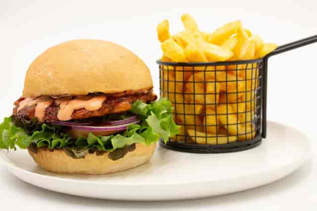 Gourmet burger and golden fries at Delta Café, ideal for casual dining events and catering.