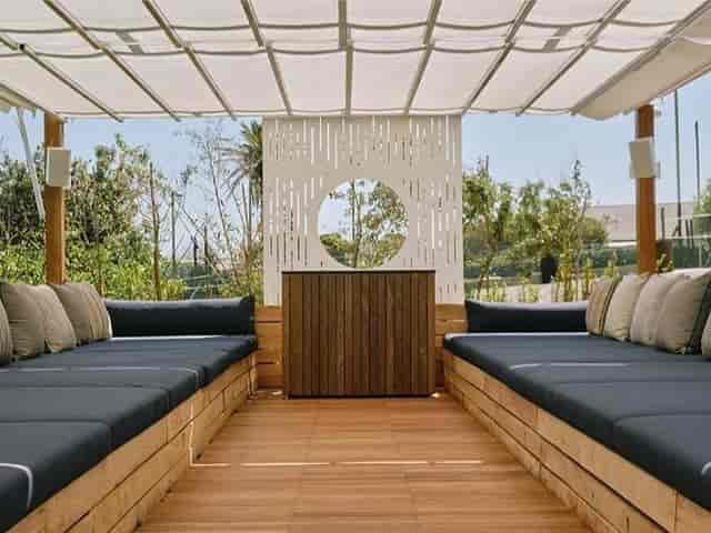 Modern outdoor lounge area with comfortable seating for networking events at The Glen Club.