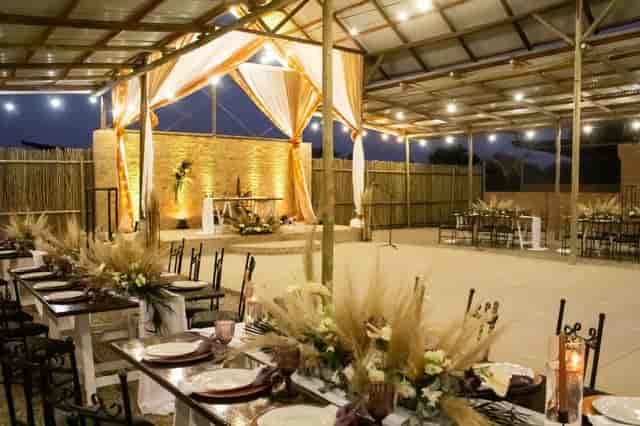 Outdoor restaurant venue with rustic floral centerpieces, perfect for elegant weddings.