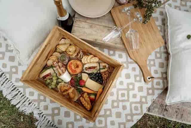 Gourmet picnic spread with cheeses and fruits at The Vineyard for outdoor networking events.