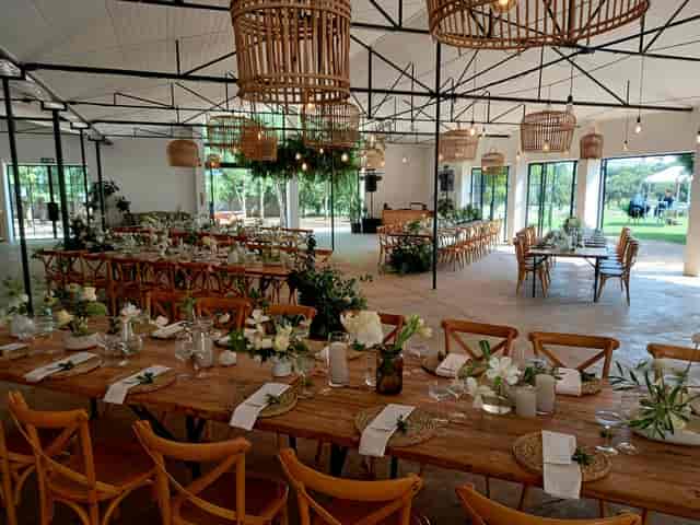 Wattle Forest event space with rustic tables for elegant weddings and corporate functions.