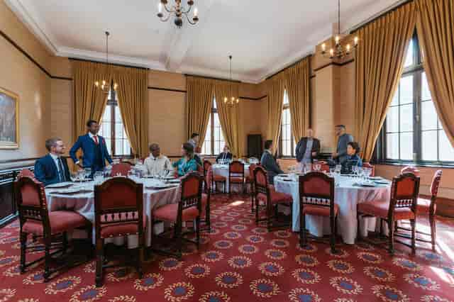 Elegant Mvela Room at Rand Club set for formal corporate gathering with fine dining.