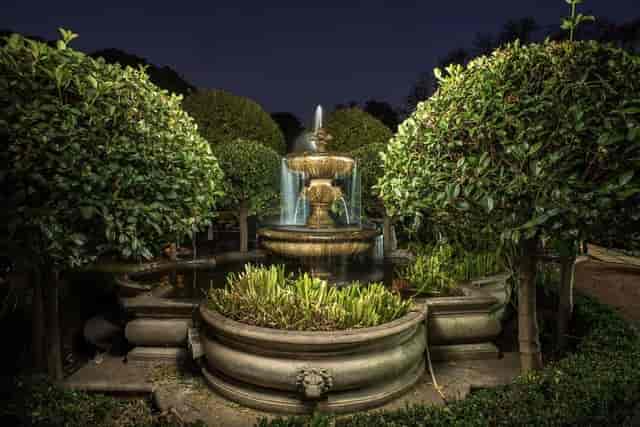 "Illuminated fountain in River Meadow Manor for elegant outdoor events and receptions."