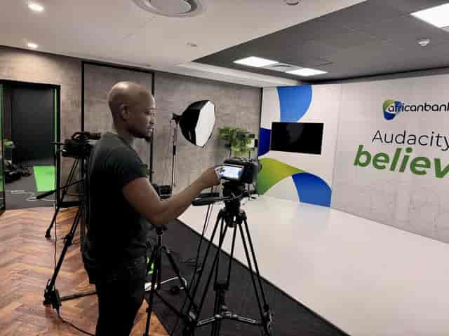 Video production setup for a hybrid event with camera equipment and studio lighting.