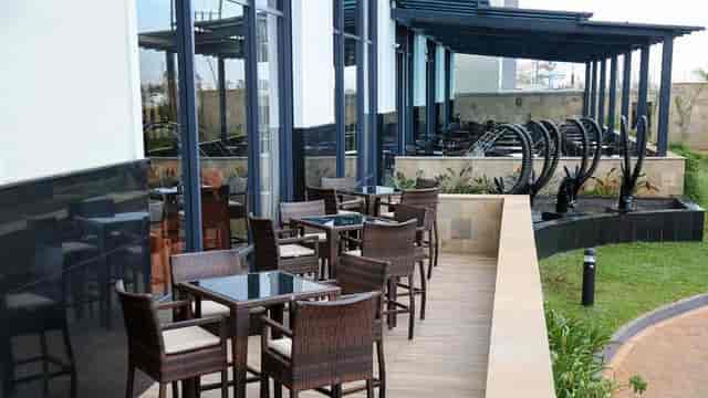 Stylish outdoor conference area with modern wicker furniture at Hilton Garden Inn Nairobi.