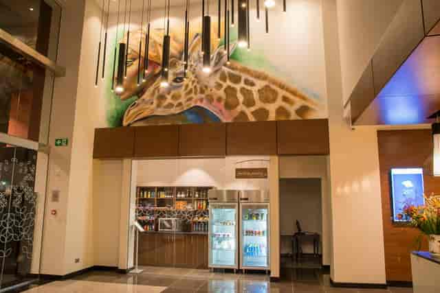 Pavilion Suite at Hilton Garden Inn Nairobi Airport with giraffe mural, ideal for events.