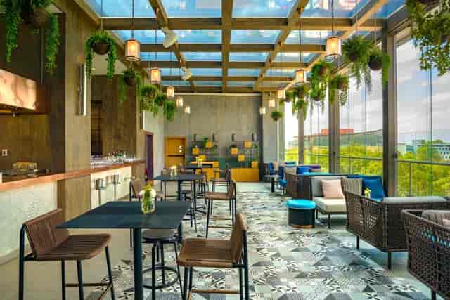 Modern event space with glass ceiling, perfect for meetings and upscale gatherings.