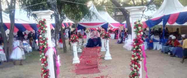 Stunning outdoor wedding venue with elegant tents and floral columns.