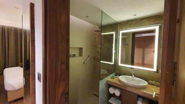 Modern hotel bathroom at Emara Ole Sereni, featuring sleek design and ambient lighting.