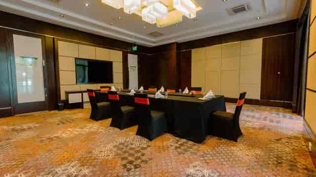 Modern meeting room with dark wood accents for corporate events at Crowne Plaza Nairobi.