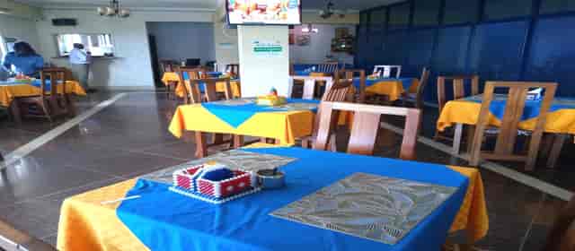 Starehe Restaurant at Meru Paramount Hotel, vibrant event space with bright blue and orange decor.