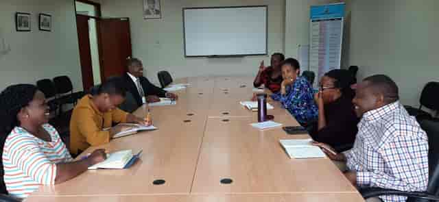 Kenyatta University conference room with engaged attendees in a collaborative meeting setting.