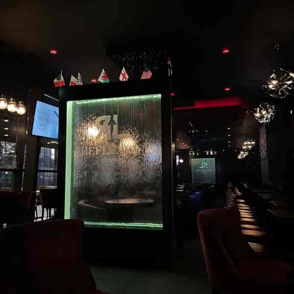 Reflexion Lounge bar with illuminated water wall for stylish corporate and multicultural events.